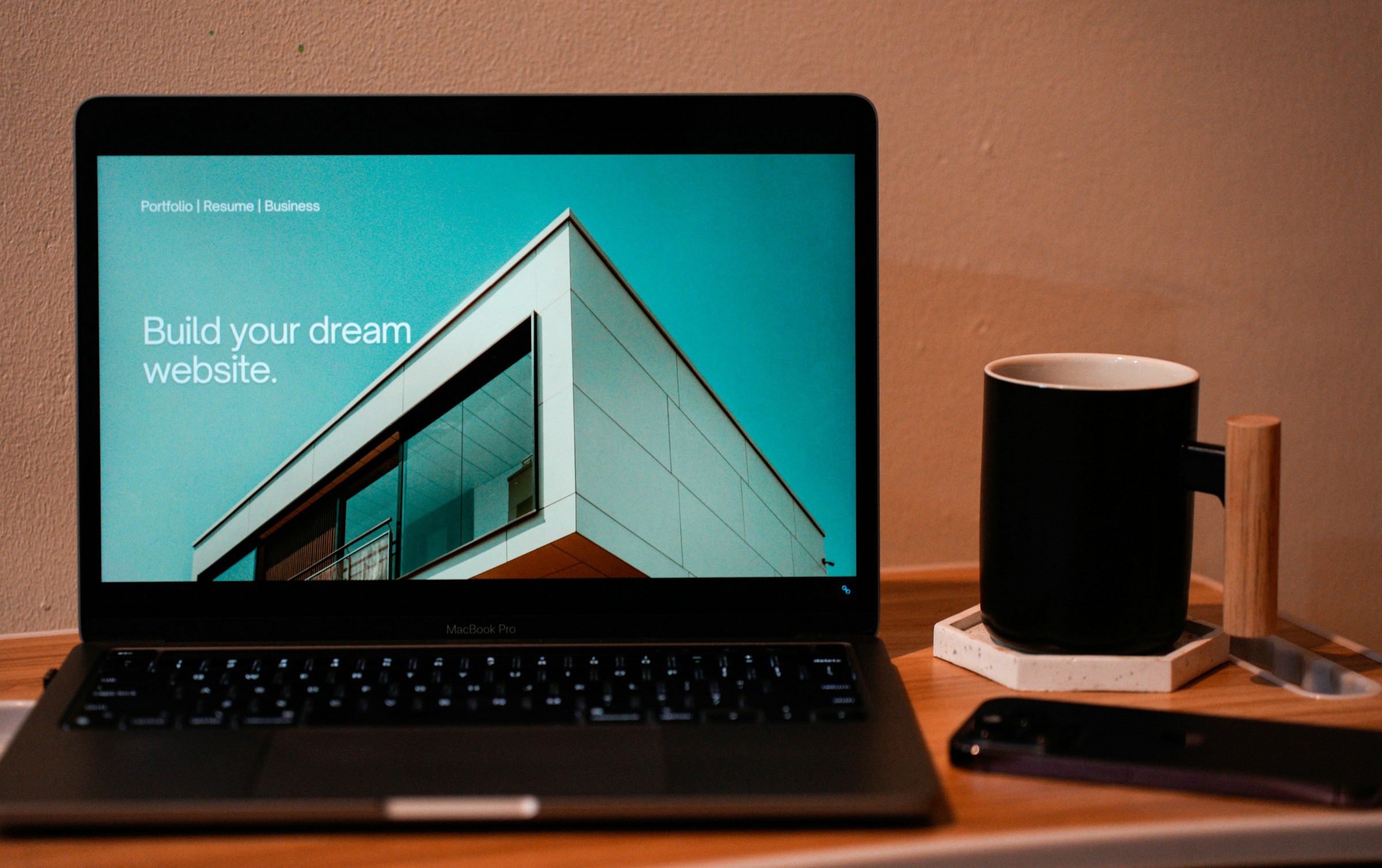 A laptop on a desk showing a website design in progress