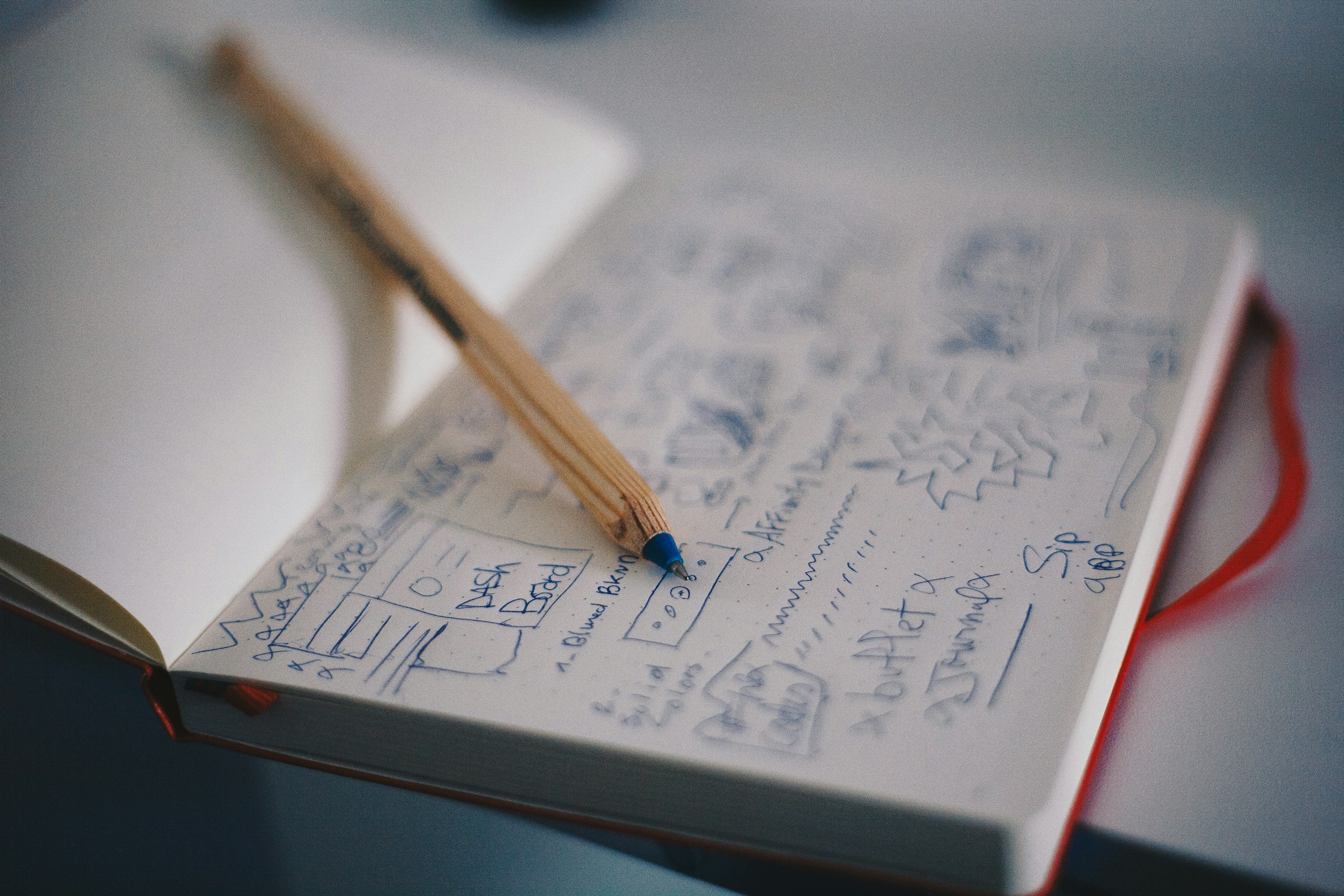 A notebook full of hand-drawn app screens and notes